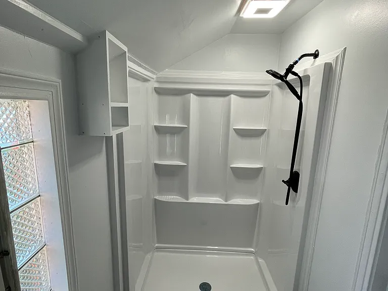 Bathroom shower upstairs - vented to keep air fresh, with shower light with integrated bluetooth speaker, multimode showerhead, with varied storage options