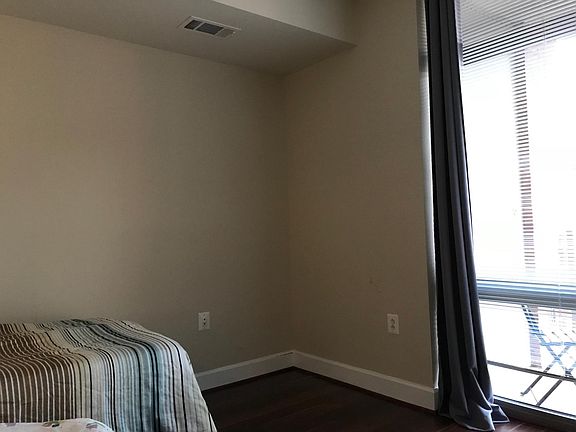 bedroom w floor to ceiling window