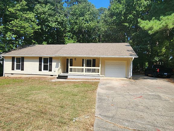 House photo with one car garage and extra parking