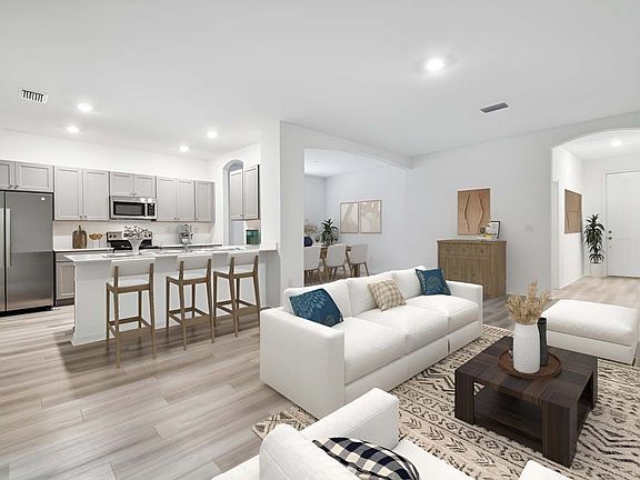 Juno new construction home plan interior open concept living great room to kitchen at Lanier Acres i