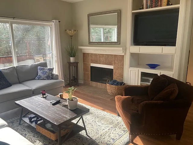 Living Room with fireplace and sliding glass door to backyard patio