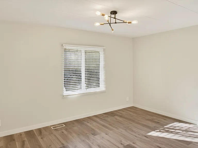Primary Bedroom with Sputnik Light Fixture and Natural Light