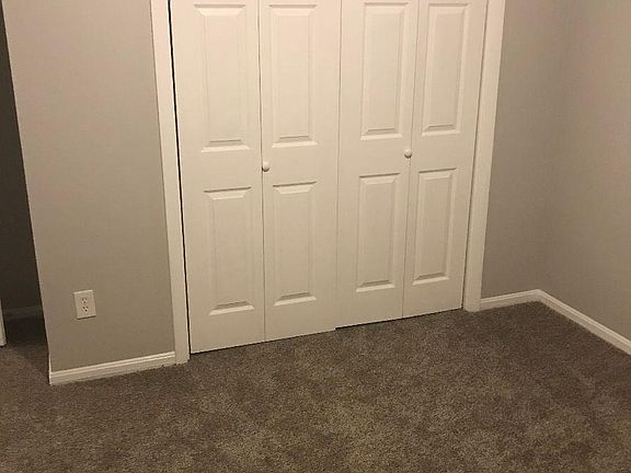 Bedroom with carpet and closet