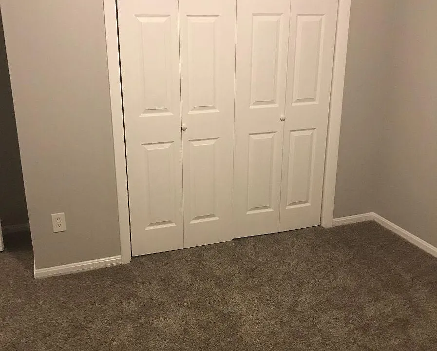 Bedroom with carpet and closet