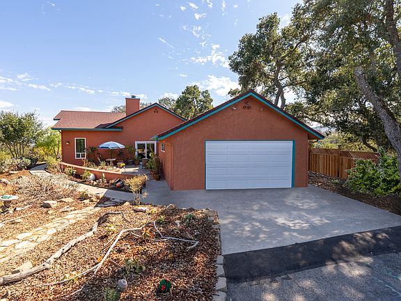 Front view of two car garage and patio off the formal dining room. Gardens have all been re planted with beautiful cactus and seasonal flowers.