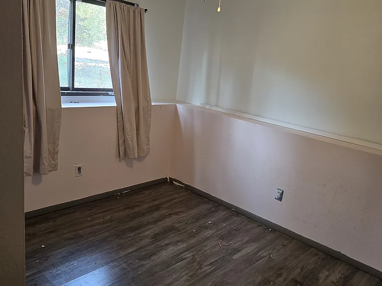Bedroom #3 downstairs w/view to street.