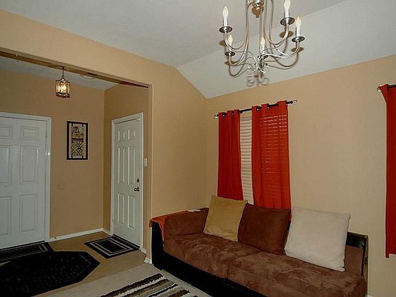 The front door opens to tile flooring and an elegant formal dining room.