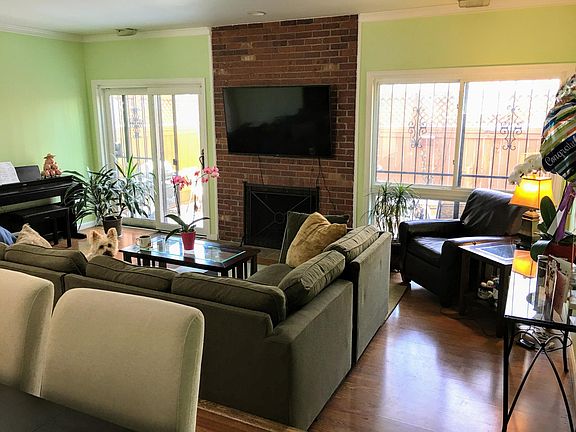 Sunken living room with exposed brick, gas fireplace, and lo