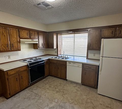 Kitchen with refrigerator and ice maker
