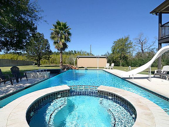 This is the ideal spot for the family and it's also perfect for entertaining.  Notice the slide, the Deck that overlooks the pool and the water fountains off to the left.