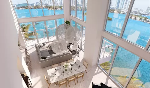 Double-height windows usher in fantastic Biscayne Bay views. - Flamingo Point