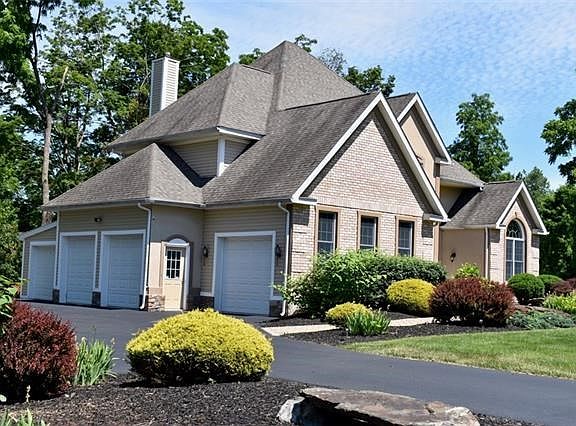 Four car garage with one bay fully separated offering custom workshop and room to spare for "smaller wheels."