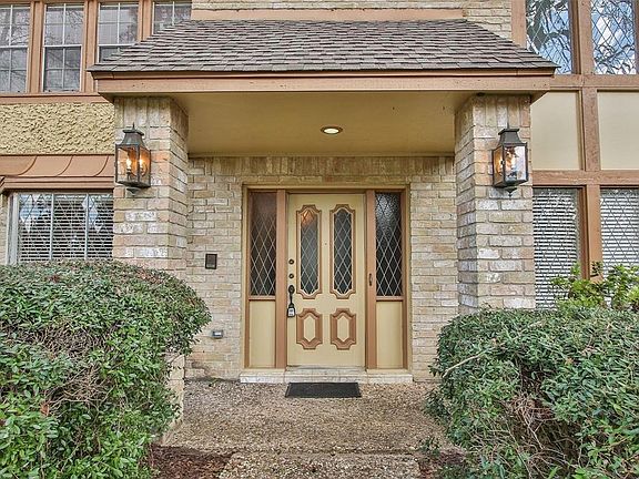 A covered front porch and leaded glass door welcomes guests to this stately home.