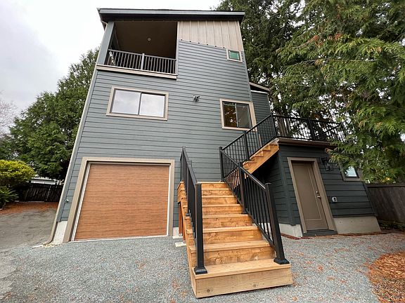 Back side of the home with stairs leading up to the deck.