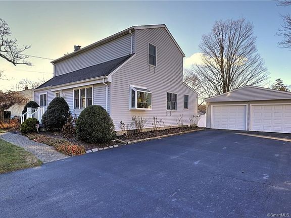Extra wide, paved driveway leads to two car garage!