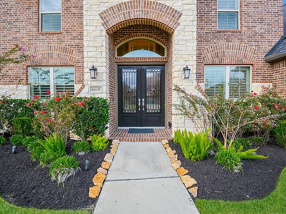 Even before you walk inside, you notice the professional landscaping, soaring entryway with stone surrond and arched brick detailing. Double wrought-iron and glass doors complete the pictures