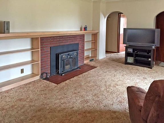 Woodburning insert keeps the living room nice and cozy during the winter months.  The floors are all carpeted but there are wood floors underneath with the exception of the kitchen and bathrooms.