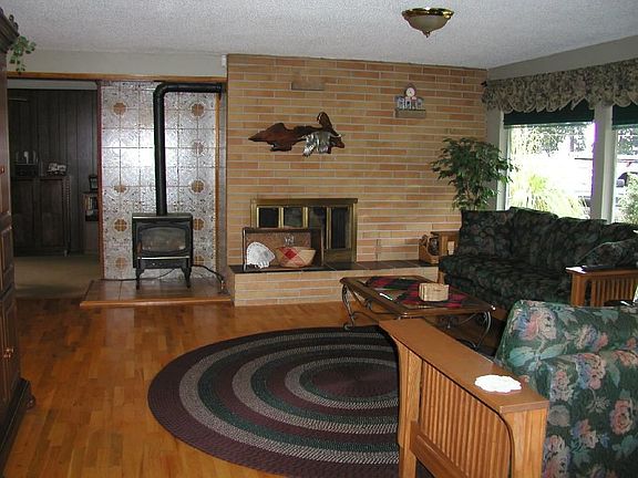 Livingroom w/propane stove, fireplace & hardwood floors