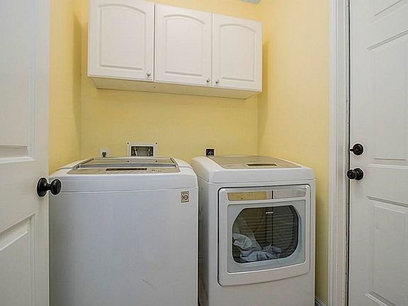Utility Room Just Off Of Garage*Cabinets Over Applainces.