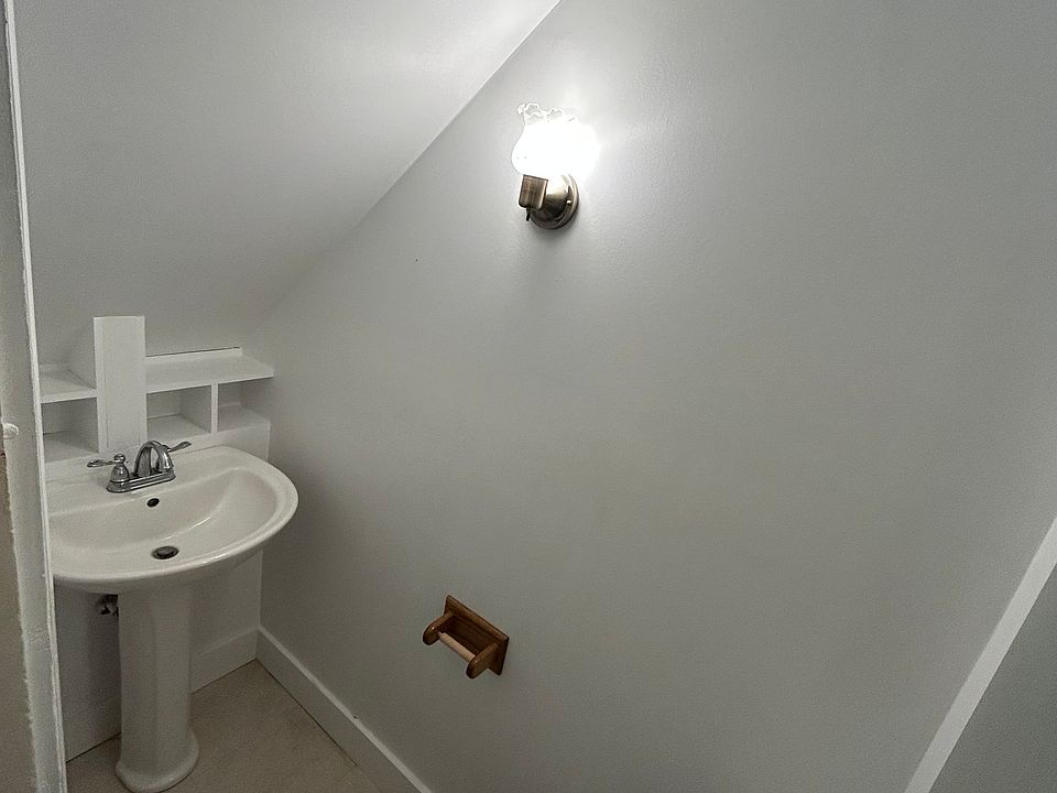 Newly remodeled half bathroom/ toilet closet under stairwell.