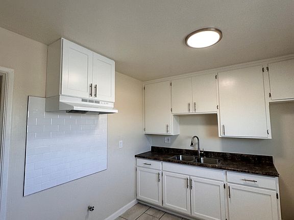 Freshly painted kitchen, new backsplash, range hood and cabinet