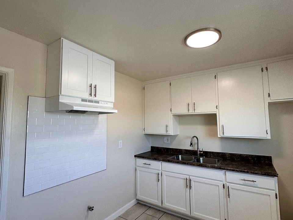 Freshly painted kitchen, new backsplash, range hood and cabinet