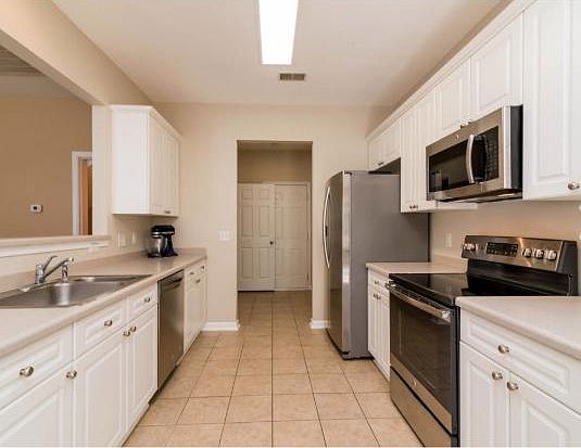 Spacious Kitchen with Stainless Steel Appliances leading into 2 car Garage