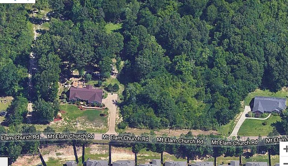 Wooded lot betwn two houses