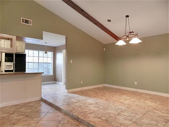 Formal dining room with updated lighting fixture. Tile and hard surface in all but one room.