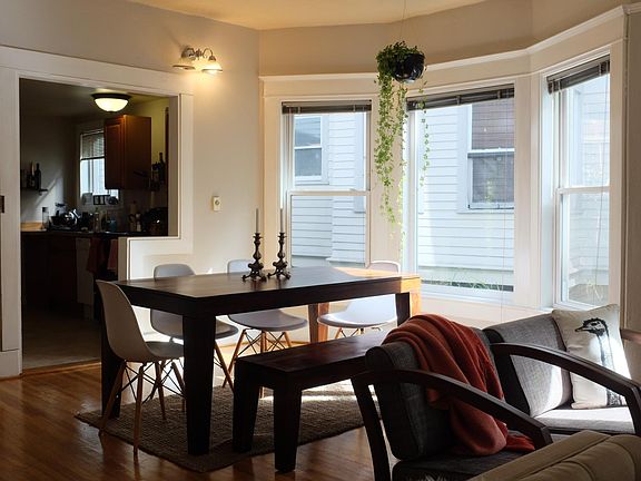 Dining area with bay windows - kitchen in the background.