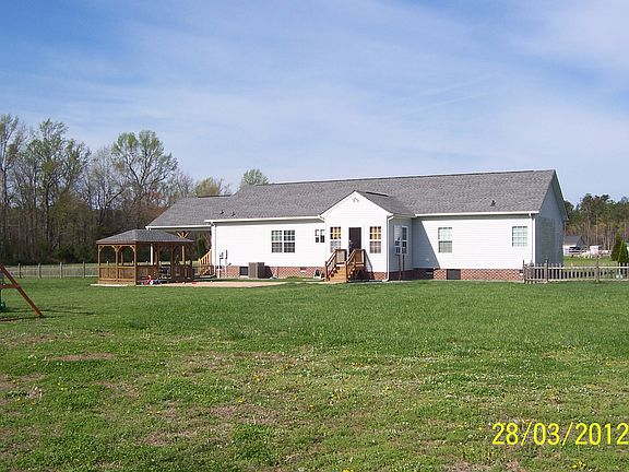 Back of house with gazebo an