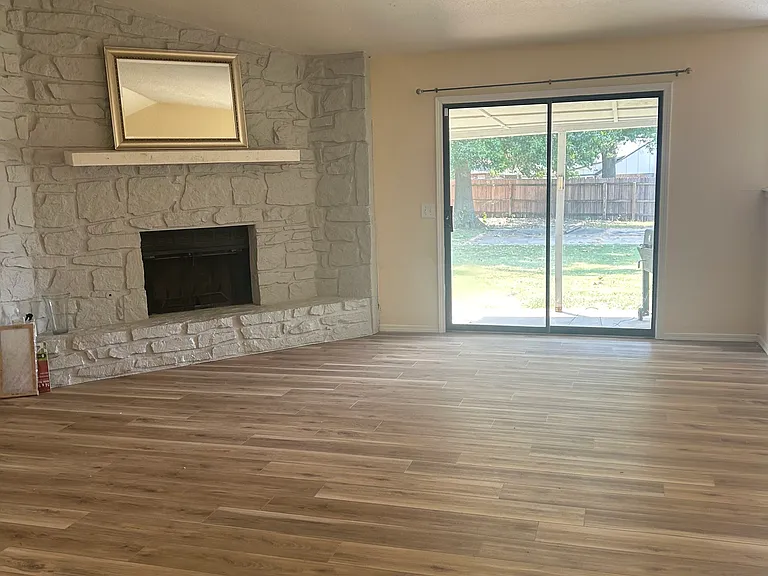 Living Room with fireplace and door to back porch and yard.