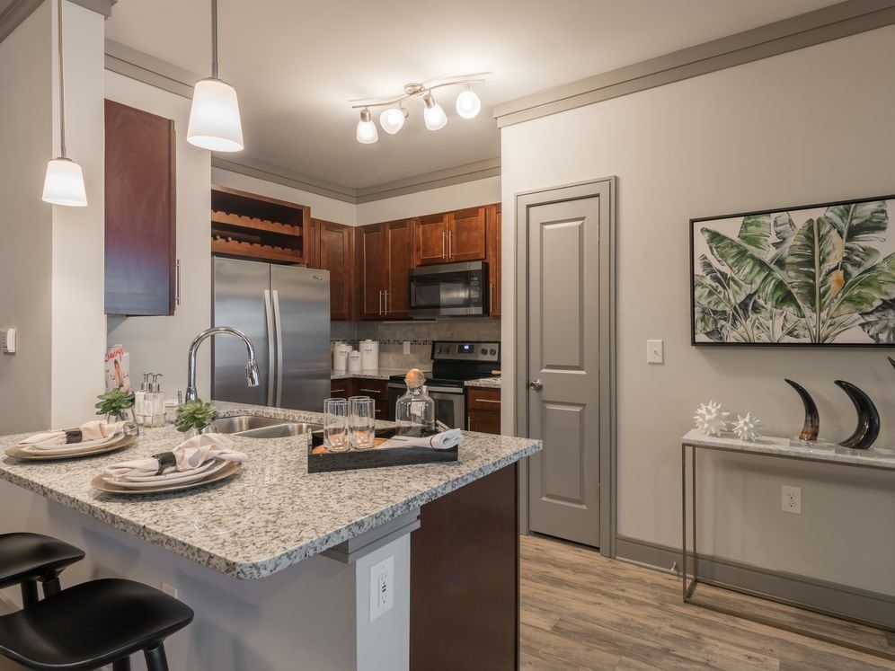 Modern Kitchens with oak shaker-style cabinetry, pendant lighting, granite countertops, and stainless steel appliances
