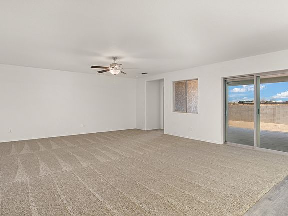 Expansive family room with a ceiling fan provides the perfect space for game nights.