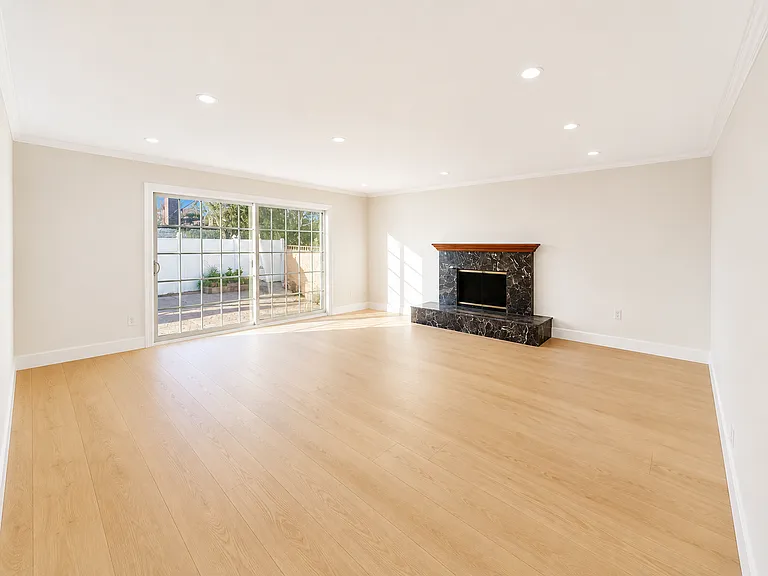 Large and bright living room - Brand new laminate wood flooring and fresh paint throughout house.