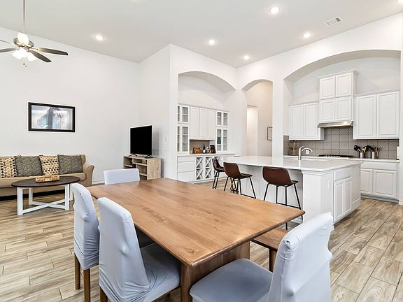Open kitchen, dining, and living room area with 20' ceilings