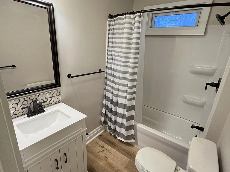 All new bathroom including vinyl flooring. There is a full bathroom on the second floor and a half bathroom off the kitchen.