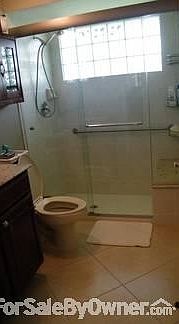 Bathroom : Glass shower enclosure, cherry wood cabinets, granite top
