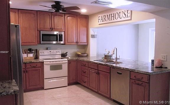 Bright and airy large eat in Kitchen with lots of wood cabinets and granite countertops