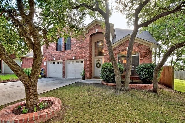 Lovely brick faade and mature trees welcome you to this four bed room home with updated kitchen, flooring and baths.