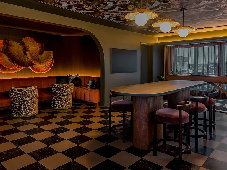 A black and white checkered floor in a room with a bar.