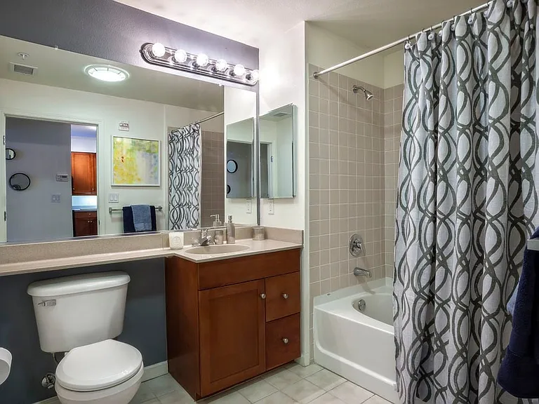 Classic Package I bath with cherry cabinetry, laminate countertops, and tile flooring