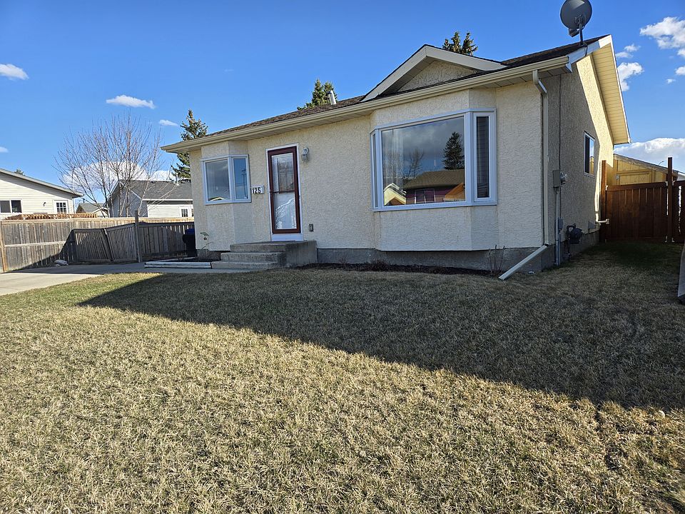 View to front and separate, main entrance for upstairs. Parking pad at left. (1 spot available + street parking)