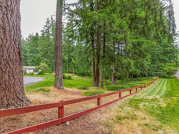 The front of the property abutting the street.  There is nice privacy with  the beautiful grounds.  