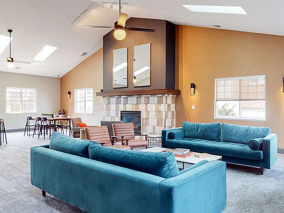 Spacious community room with cozy seating, perfect for gathering with neighbors.