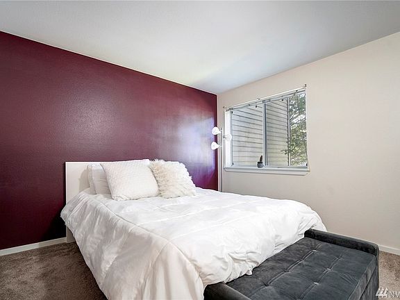 Large picture window fills the master bedroom with lots of natural light. Such a nice, large room, it fits a king-size bed with ease.