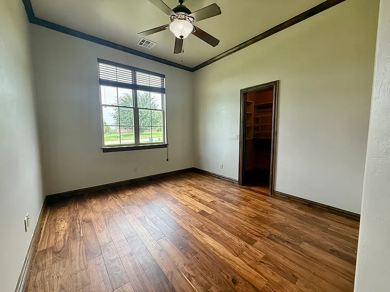 This is the second bedroom on the opposite side of the house from the master bedroom. Acacia floors w/large walk-in closet. This can be a second office or a bedroom. Personally, my dad used the library as his office and my mom used this as her office.