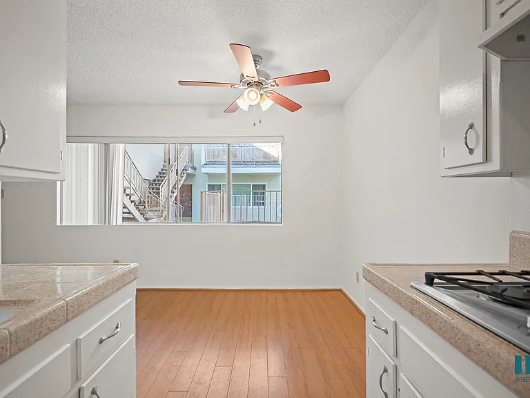 Kitchen and Dining Room with Windows and a Ceiling Fan