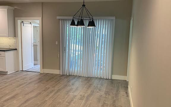 View of dining area with Kitchen on the Left as seen from the living room