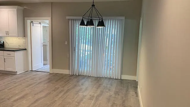 View of dining area with Kitchen on the Left as seen from the living room